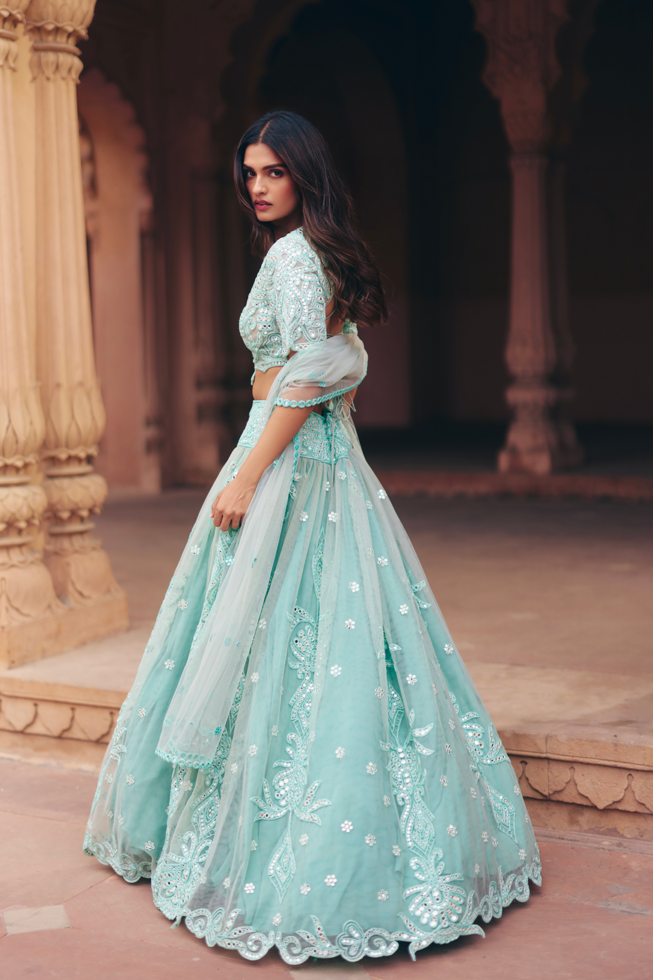 Aqua green mirror-embroidered blouse with a flared lehenga and sheer dupatta