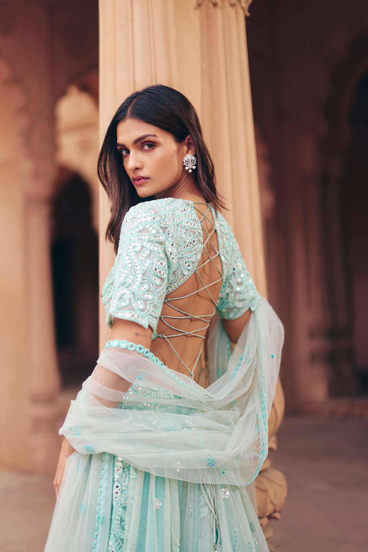 Aqua green mirror-embroidered blouse with a flared lehenga and sheer dupatta