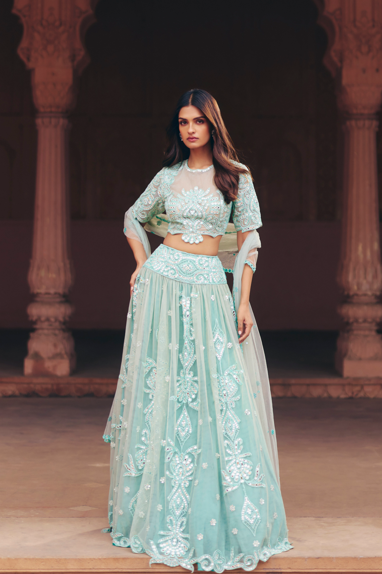 Aqua green mirror-embroidered blouse with a flared lehenga and sheer dupatta