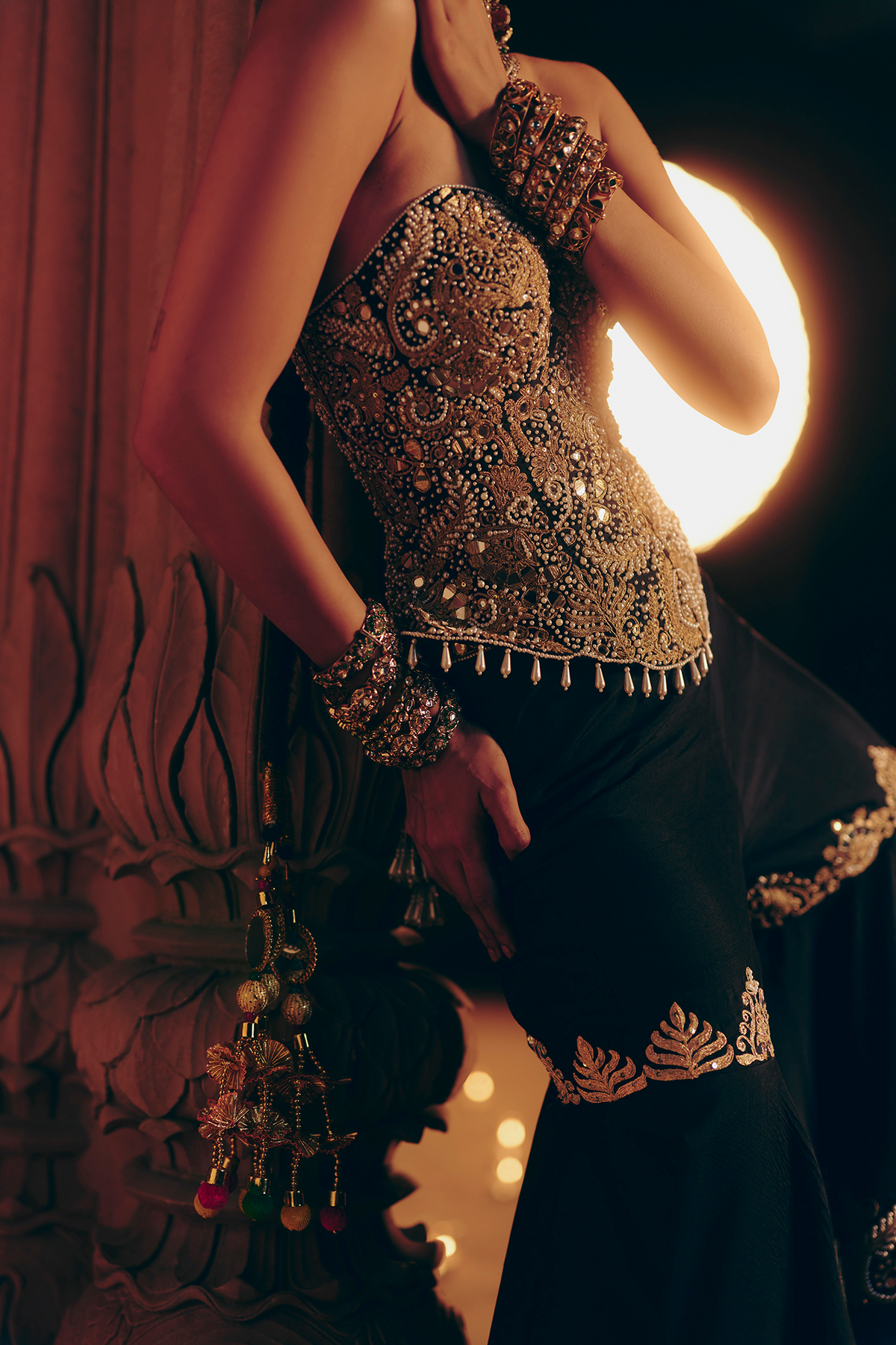 Black corset blouse and tiered sharara with gold cord and mirror embroidery