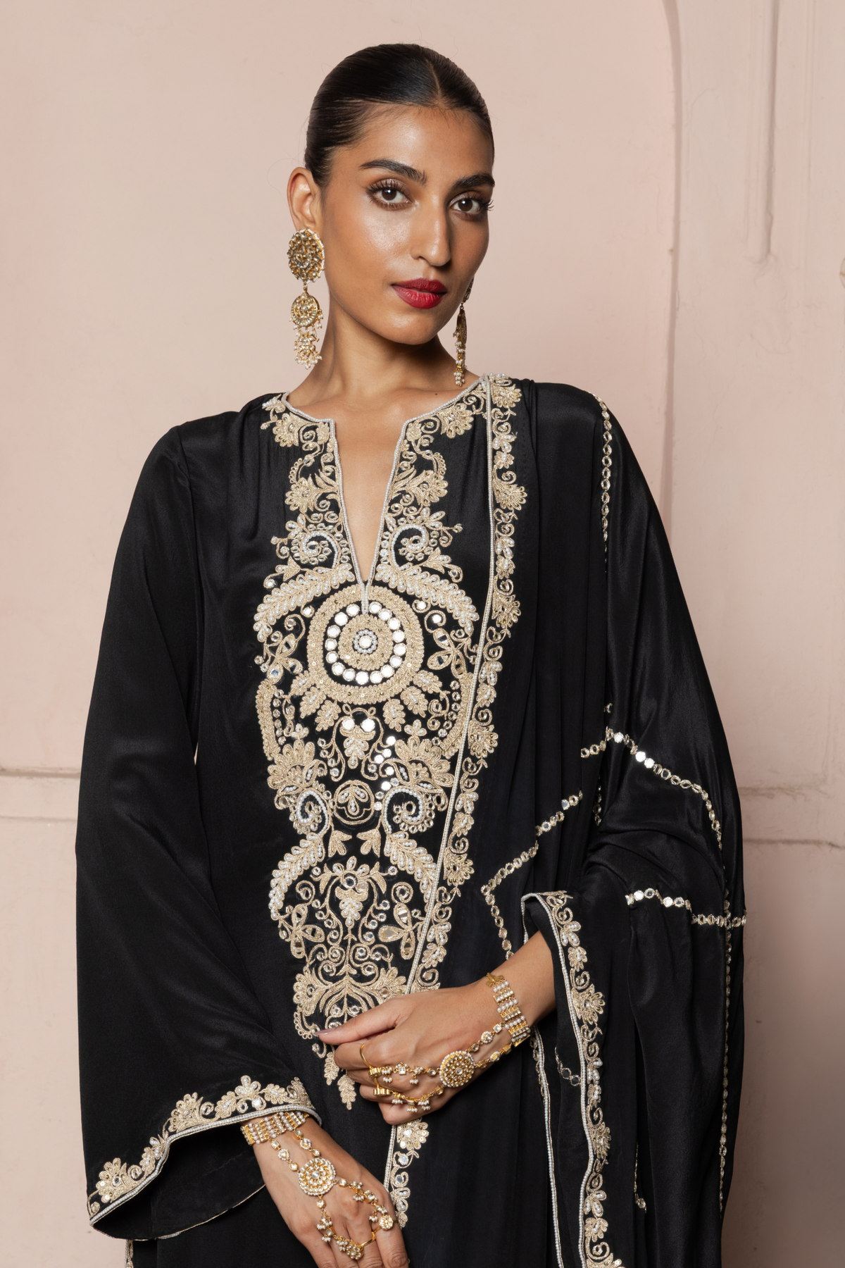 Black kurta set with a checked dupatta featuring gold cord and mirror embroidery