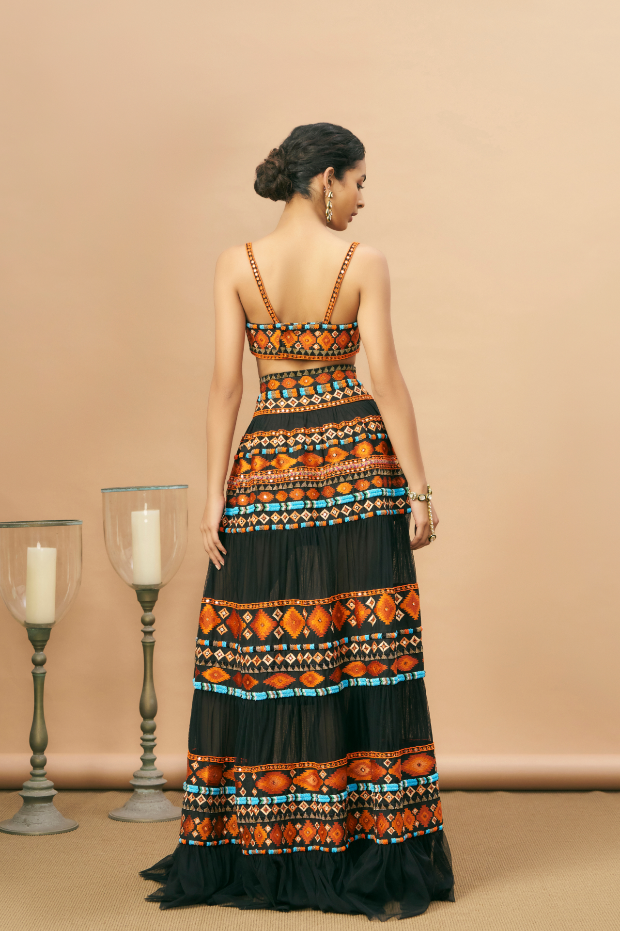 Black strappy blouse and tiered skirt with Aztec embroidery