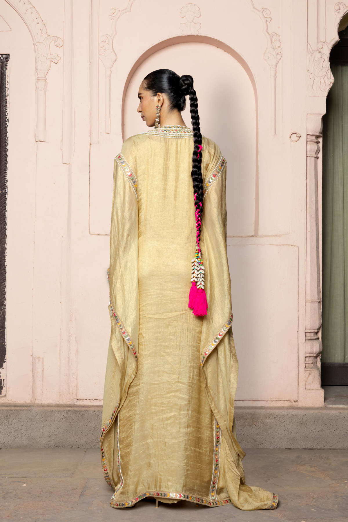 Gold kaftan with a mirror-embroidered neckline.