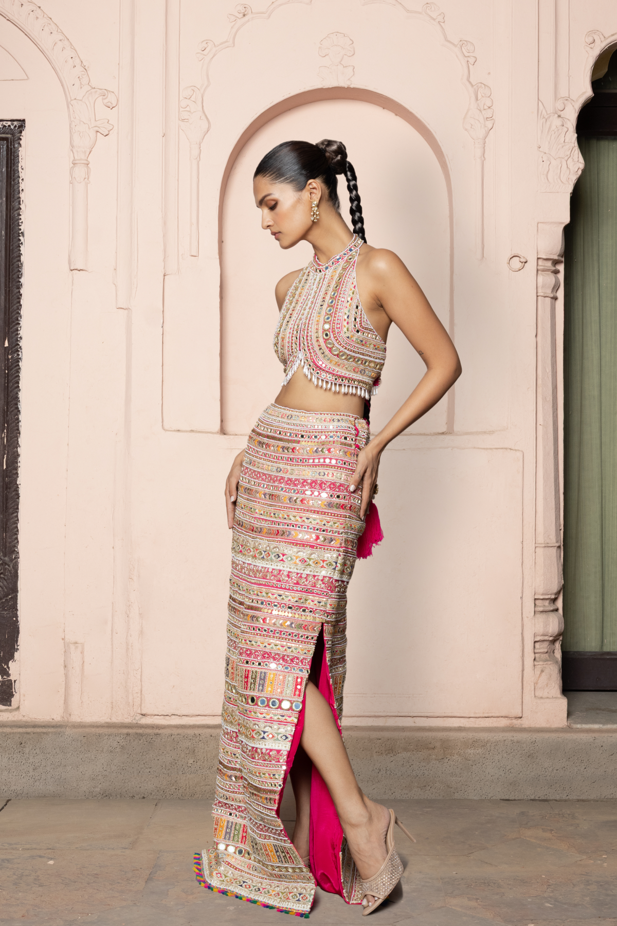 Hot pink straight skirt with embroidered borders and mirror embellishments, paired with a coordinating embroidered blouse.