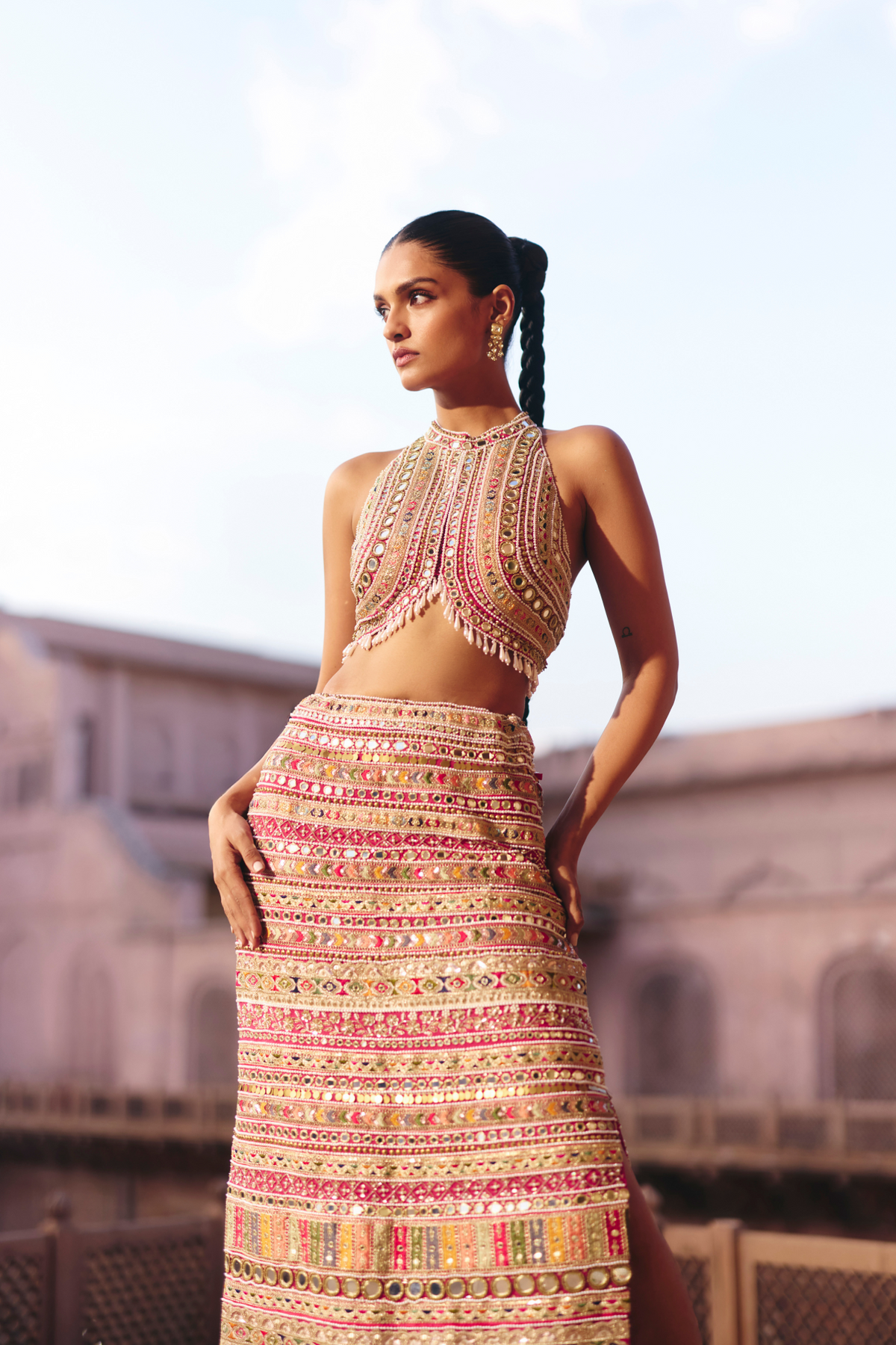 Hot pink straight skirt with embroidered borders and mirror embellishments, paired with a coordinating embroidered blouse.