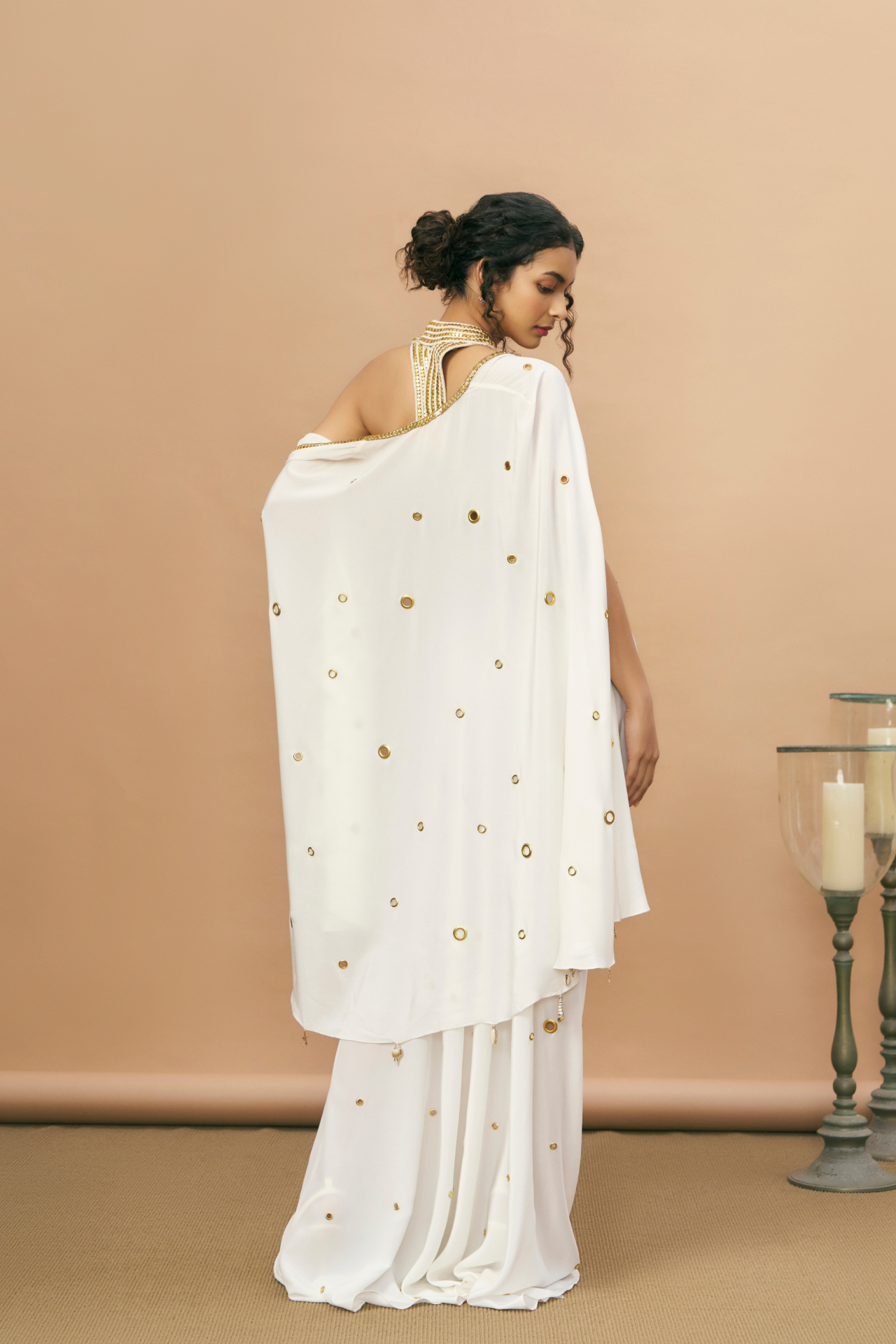 Ivory and gold studded rope-embroidered top with draped skirt and sheer cape