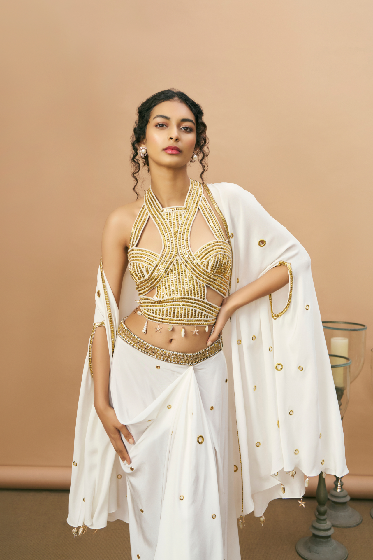 Ivory and gold studded rope-embroidered top with draped skirt and sheer cape