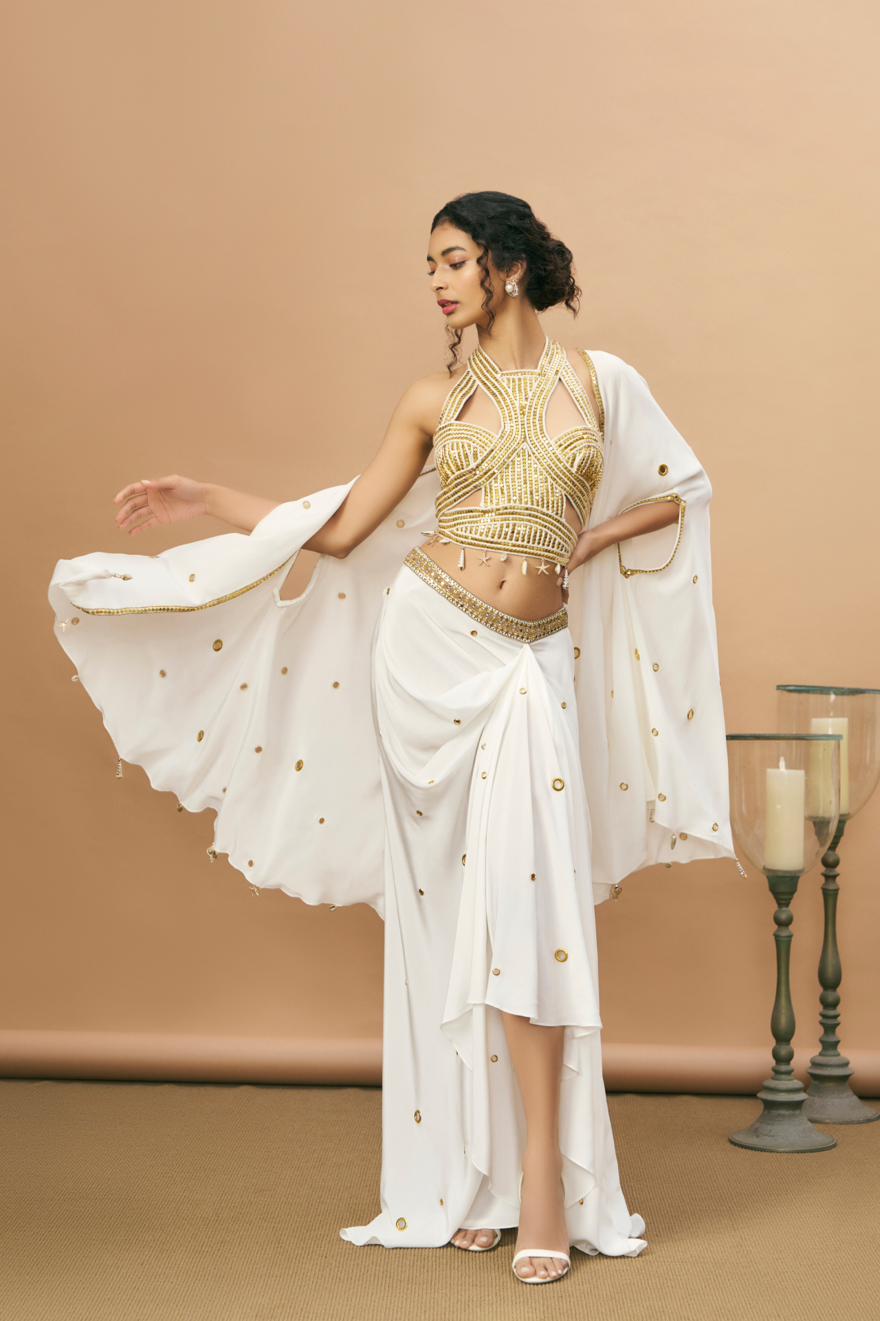 Ivory and gold studded rope-embroidered top with draped skirt and sheer cape