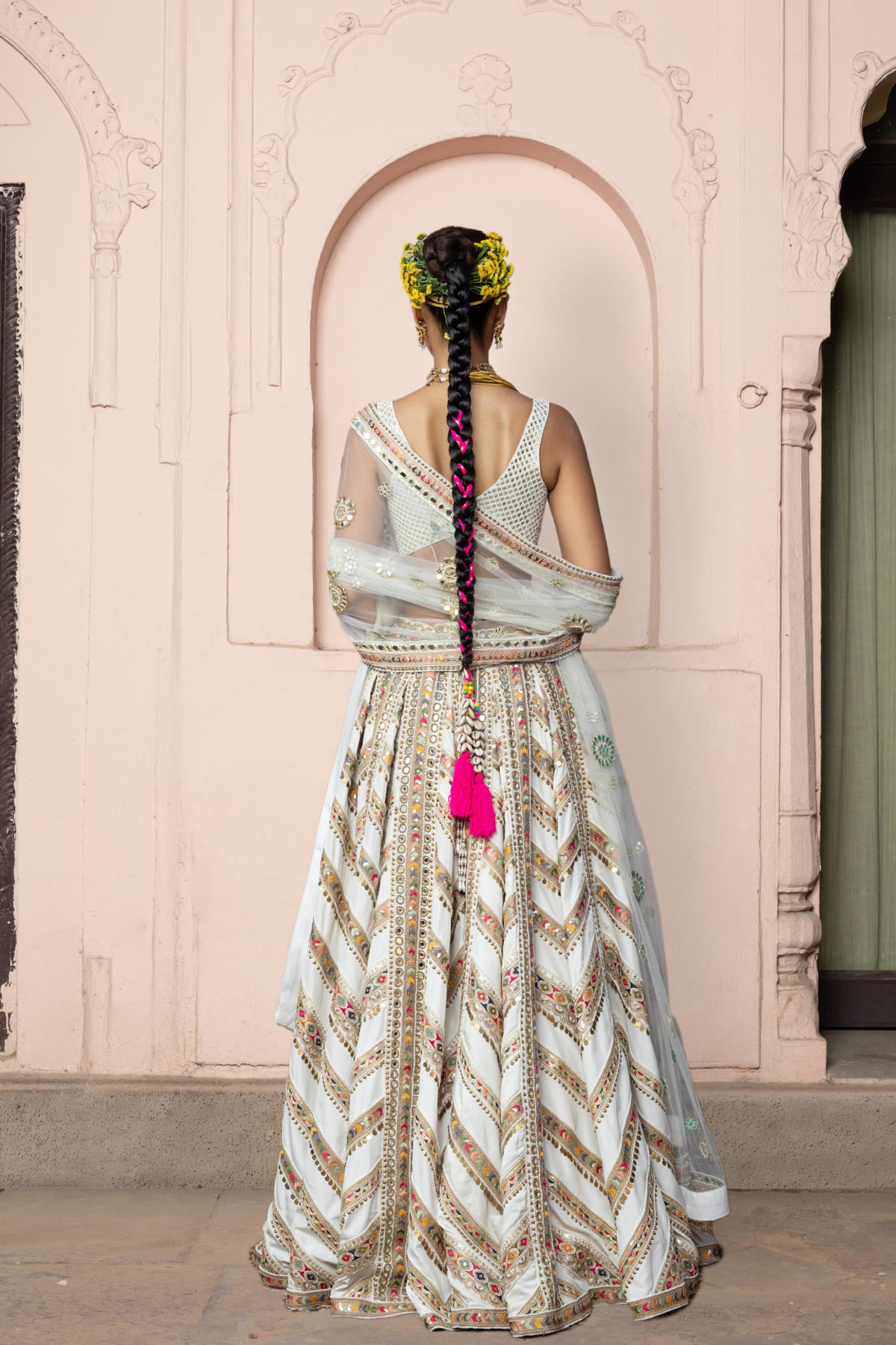 Ivory lehenga with mirror embroidery, paired with a mirror-embroidered blouse and matching dupatta.