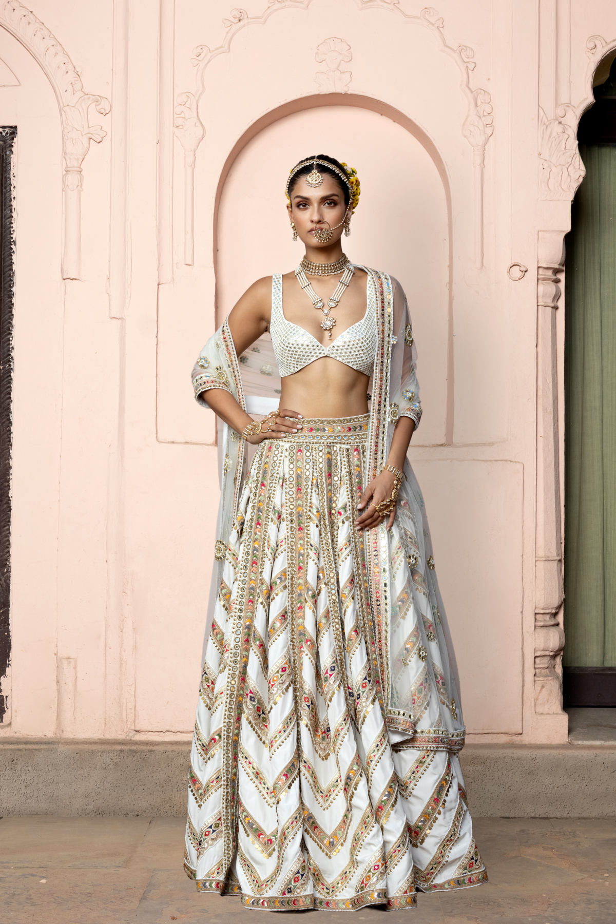 Ivory lehenga with mirror embroidery, paired with a mirror-embroidered blouse and matching dupatta.