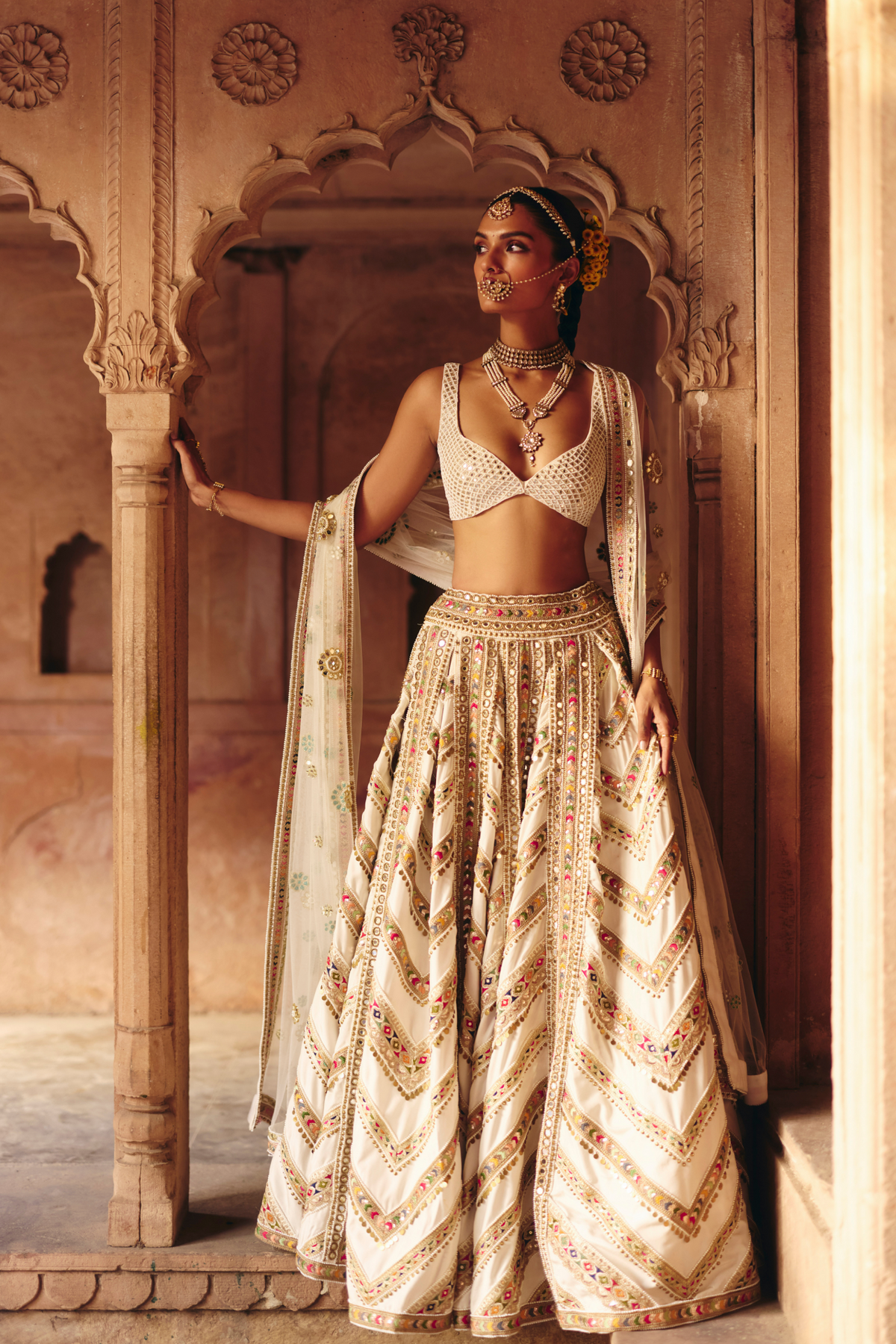 Ivory lehenga with mirror embroidery, paired with a mirror-embroidered blouse and matching dupatta.