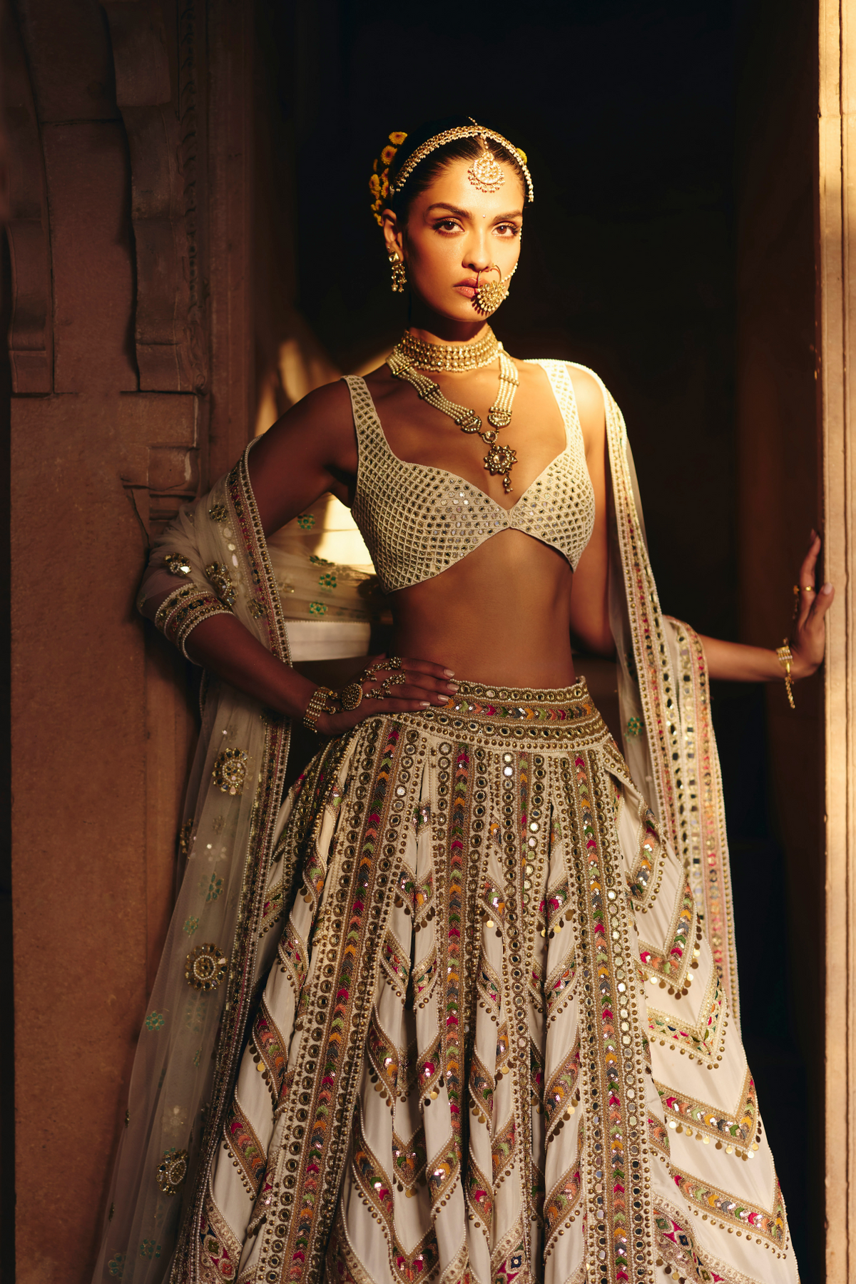 Ivory lehenga with mirror embroidery, paired with a mirror-embroidered blouse and matching dupatta.