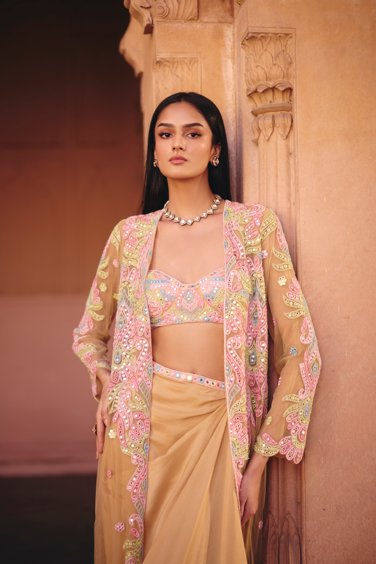 Nude multicolour mirror-embroidered tube blouse with a draped skirt, embroidered belt and long jacket
