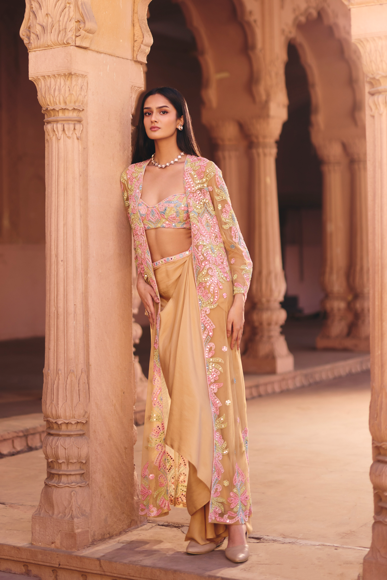 Nude multicolour mirror-embroidered tube blouse with a draped skirt, embroidered belt and long jacket