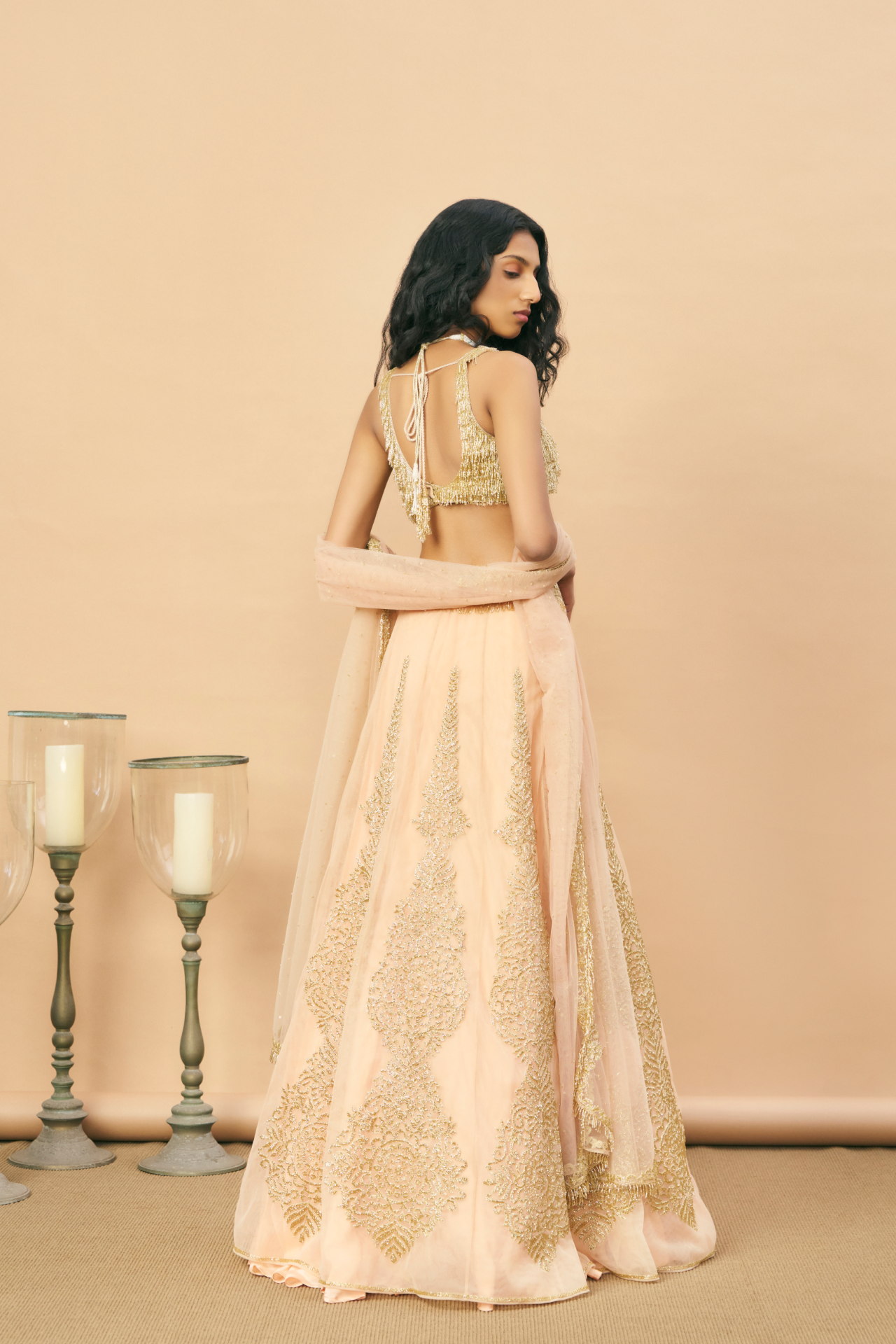 Peach panel lehenga with gold cutbead motif embroidered with gold tassel blouse and dupatta