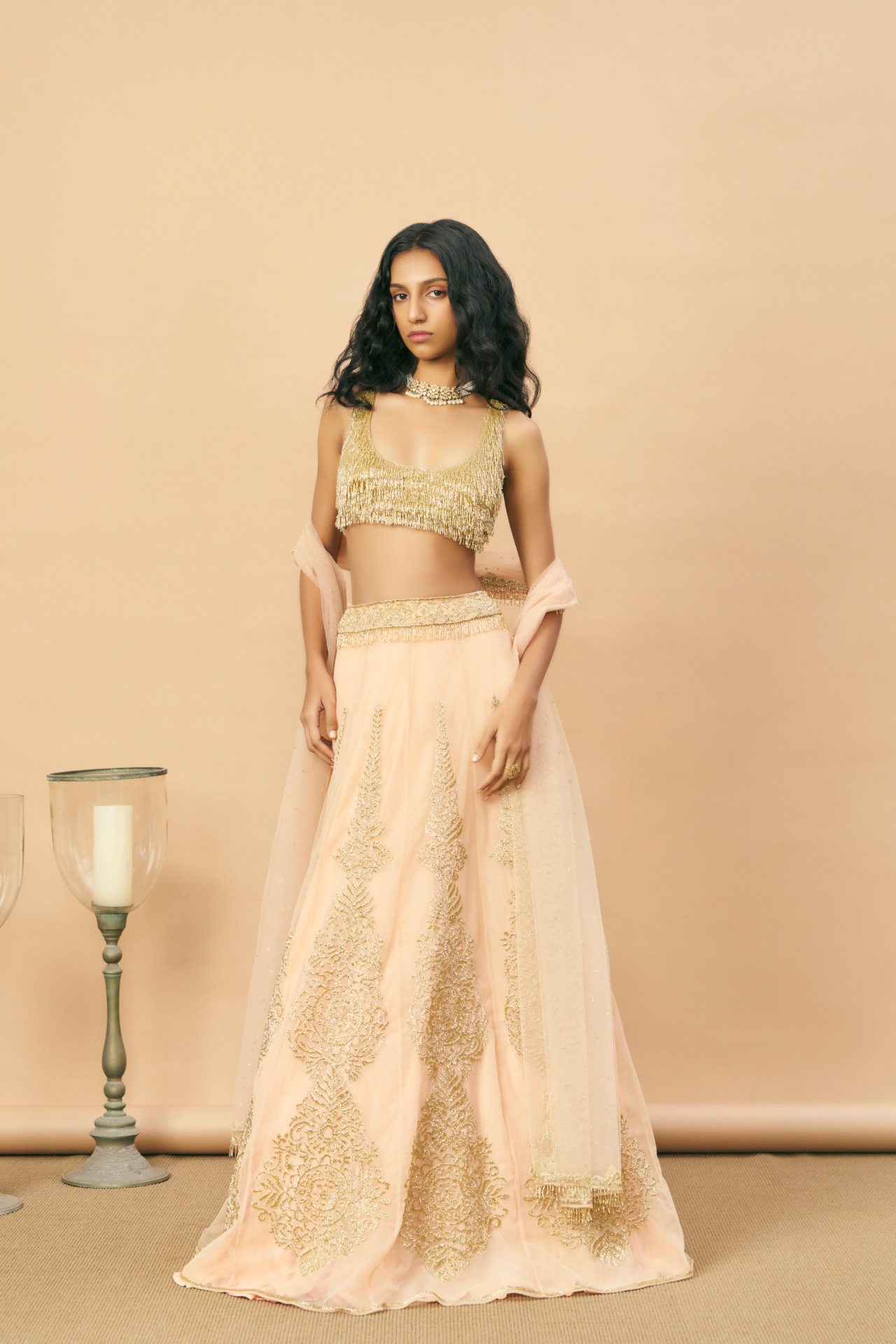 Peach panel lehenga with gold cutbead motif embroidered with gold tassel blouse and dupatta
